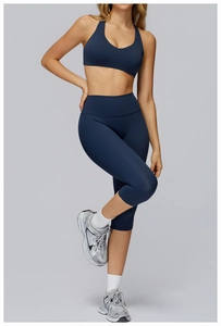 Detail view of deep blue yoga set featuring racerback sports bra and high-waisted leggings