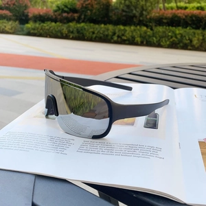 Side view of black sports sunglasses with silver mirror lenses on an open magazine