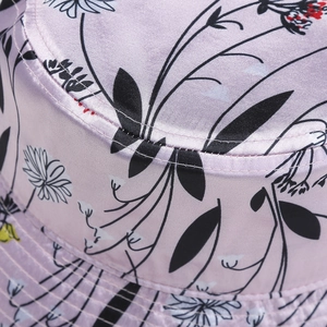 Detail of floral printed satin bucket hat with lilac base and smooth texture