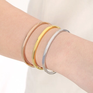 Three-color minimalist stainless steel curved bangles in gold, silver, and rose gold finishes