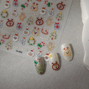 5D Christmas embossed nail stickers featuring Santa Claus and reindeer on a sheet with tips