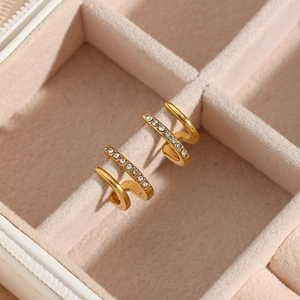 Macro detail of 18K gold plated double layer earrings with zircon inlay on velvet