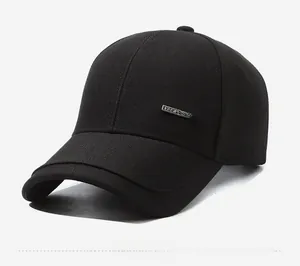 Side view of black cotton baseball cap with silver metal plate accent on stiff crown