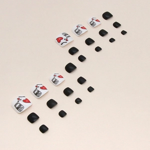 Black and white toenail press-ons featuring red hearts and True Love bottle design