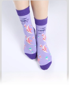 Close-up of crew socks with purple ocean life prints and contrasting heel and toe