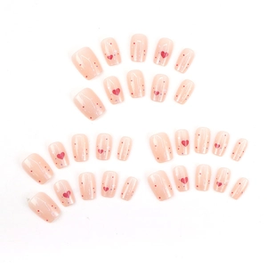 Cute pink press-on nails with red hearts and colorful dots in a square round shape