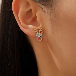 Close-up of reindeer stud earring with sparkling rhinestones and red nose for Christmas