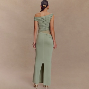 Detail view of green one-shoulder maxi dress featuring ruched fabric and back slit detail