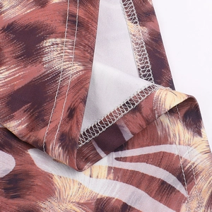 Close-up of leopard print fabric showing professional overlock stitching and high-quality seams