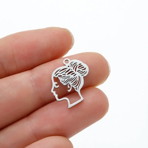 Close-up of small silver stainless steel silhouette pendant showing actual size on fingers