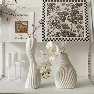 Modern wavy white ceramic vases set for minimalist home decor and floral arrangements