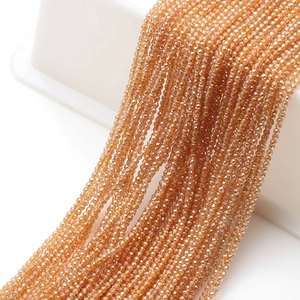 Close-up of faceted amber glass beads for DIY jewelry making and handmade crafts