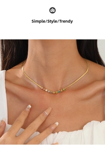 Detail of 18K gold snake chain necklace with colorful round zircon stone inlay