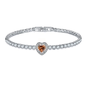 Macro detail of tennis bracelet with heart orange gemstone and round cubic zirconia