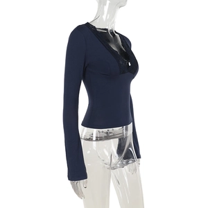 Side view of dark blue long sleeve top with black lace trim on deep V-neckline