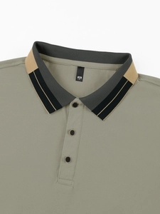 Detail of waffle knit texture and contrast striped collar on olive green polo shirt