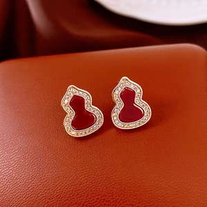 Macro shot of red gourd stud earrings with gold plating and cubic zirconia inlay