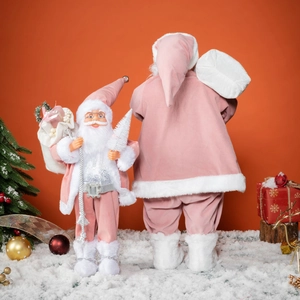 Pink and white plush Santa Claus figurines in two sizes on snowy holiday background