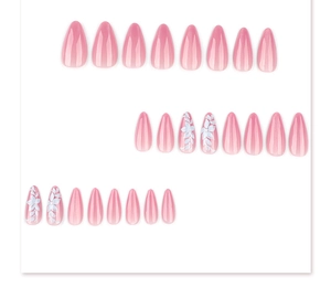 Detail of pink gradient almond nails with white floral patterns and cat-eye finish