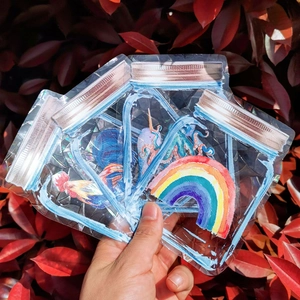 Close-up of holographic suncatcher window stickers in jar shapes with rainbow patterns