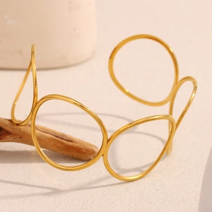 Detail of minimalist 18K gold plated stainless steel hollow circular open bangle