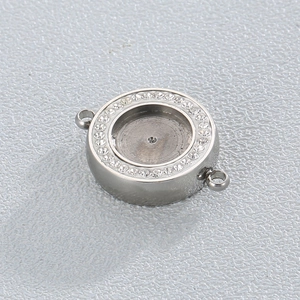 Macro view of a silver geometric stainless steel pendant with sparkling zircon rhinestones