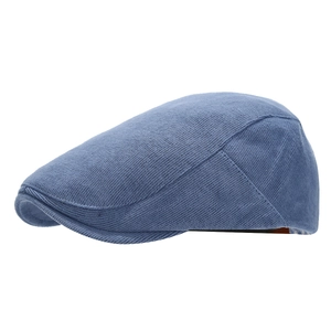 Blue knitted cotton newsboy cap with a minimalist flat top and solid color denim aesthetic