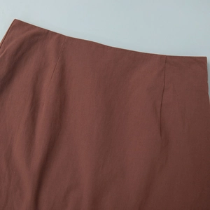 Detailed view of the dark brown high waist skirt featuring precise stitching and darts