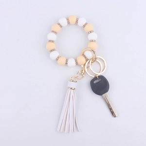 Detail of silicone beaded wristlet with white tassel and sparkling rhinestone rings
