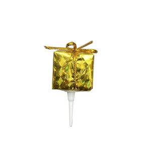 Mini gold laser gift box cake topper decoration with golden ribbon on white background