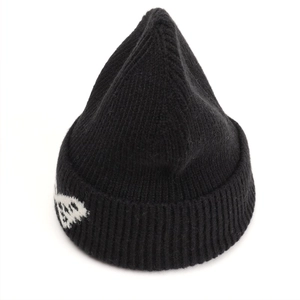 Detailed view of black ribbed knit beanie with white butterfly jacquard and folded cuff