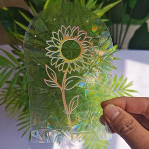 Macro shot of a holographic arch suncatcher with sunflower design reflecting rainbow light