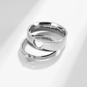 Detail of silver heart rings set with I LOVE YOU engraving and hollow heart design