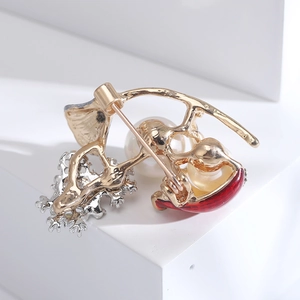 Detailed close-up of the secure safety pin clasp and gold plating on the snowman brooch
