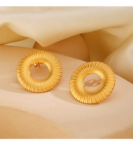 Detail of 18K gold plated titanium earrings with sunburst texture on satin background