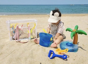 Waterproof PVC beach bag for kids shown with sand toys and a baby on a sunny shore