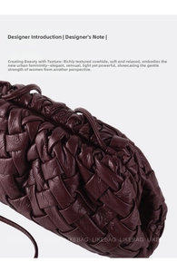 Close-up of deep burgundy woven leather texture on a stylish cloud-style croissant bag