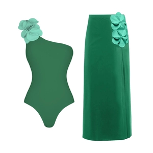 Deep green one-shoulder swimsuit set with 3D floral accents and matching slit maxi skirt