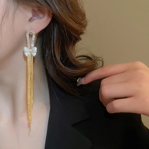 Elegant gold bow tassel earrings with zircon inlay for a sophisticated long drop look