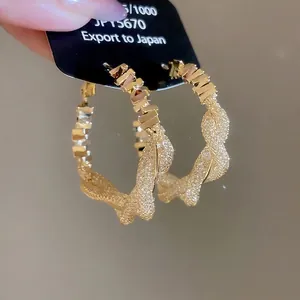Golden mesh textured hoop earrings with a twisted woven design for a stylish women's look
