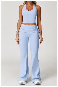 Detail of high-waisted ice blue flare leggings with drawstring waist and ruched fabric design