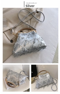 Detailed view of silver sequin fringe evening bag with gold clasp and elegant round handle