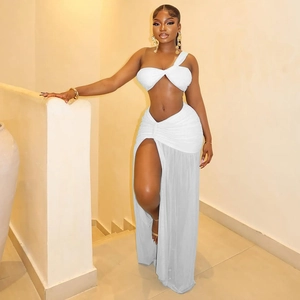 White two-piece set featuring a one-shoulder crop top and pleated high-slit maxi skirt