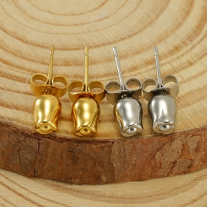Polished stainless steel tulip bud stud earrings in gold and silver finishes on wood