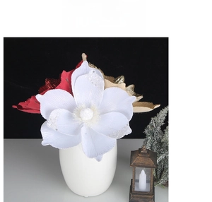 White Christmas poinsettia with silver glitter in ceramic vase with festive lantern