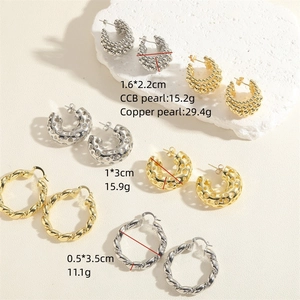 Three pairs of C-shaped earrings in gold and silver including bead and twisted styles