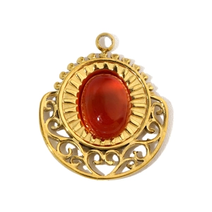 Macro shot of tiger eye stone pendant in gold plated titanium steel with cut-out details