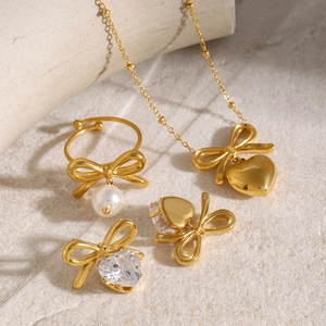 Elegant gold bow jewelry set with heart pendant necklace, pearl ring and zircon earrings