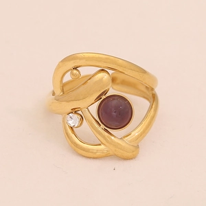 Detail of gold geometric ring featuring an oval purple gemstone and small zircon stone