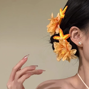 Elegant fabric flower and starfish hair clip set in vibrant orange for a coastal look